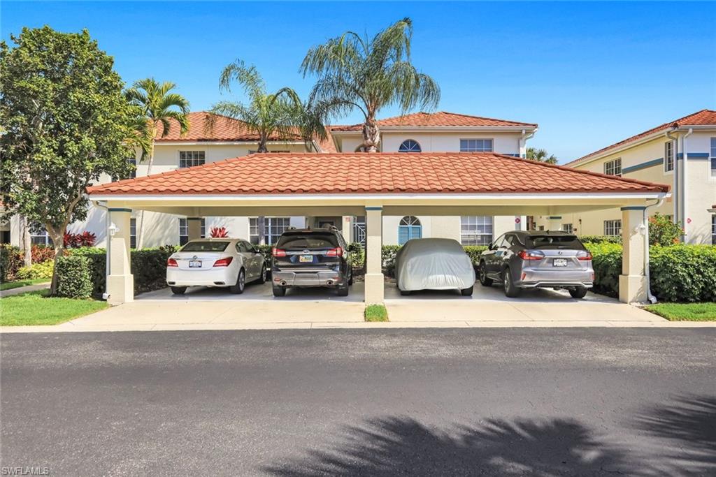 23810 Marbella Bay Road, Unit 103 Estero, FL 34135 - Photo 17 of 32 a front view of a house with garden