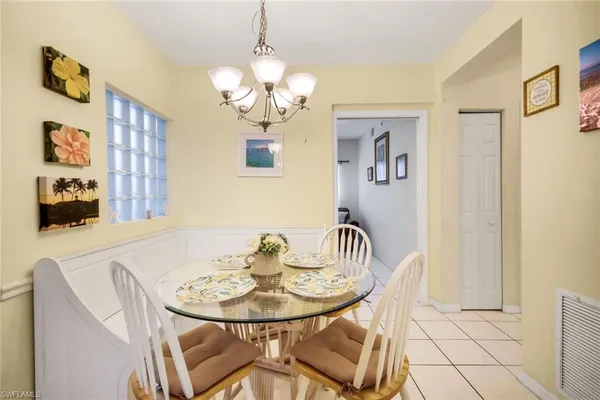 a view of a dining room with furniture and chandelier
