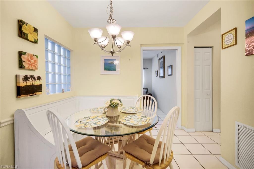 23810 Marbella Bay Road, Unit 103 Estero, FL 34135 - Photo 4 of 32 a view of a dining room with furniture and chandelier