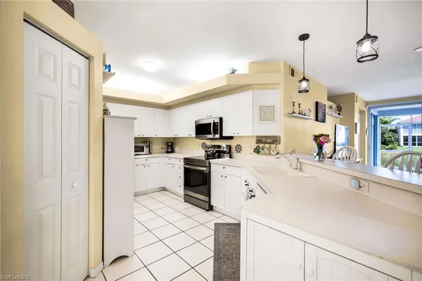a kitchen with a sink a counter top space and appliances