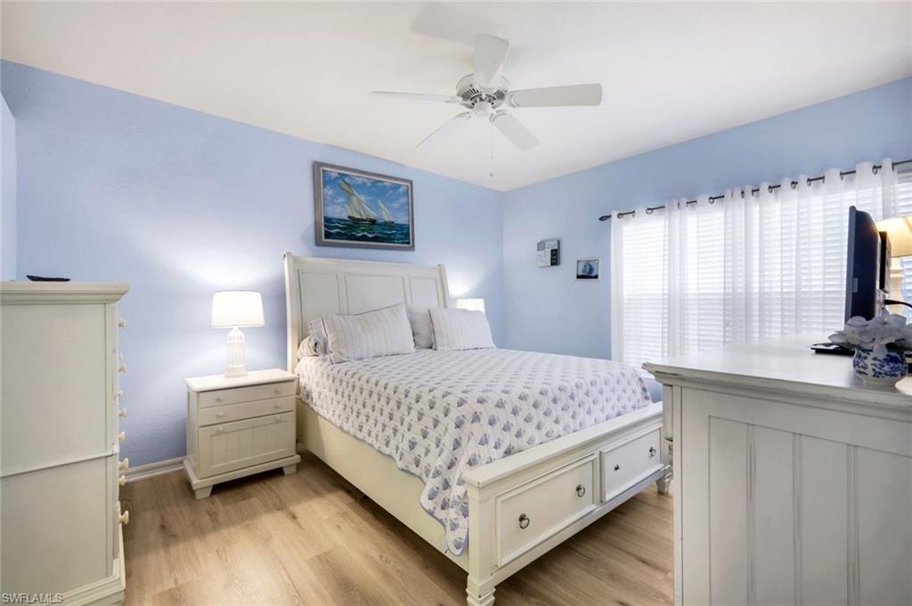 23810 Marbella Bay Road, Unit 103 Estero, FL 34135 - Photo 8 of 32 a bedroom with a bed and a flat tv screen on dresser