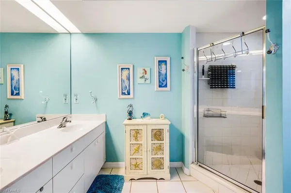 a bathroom with a sink a mirror and a shower