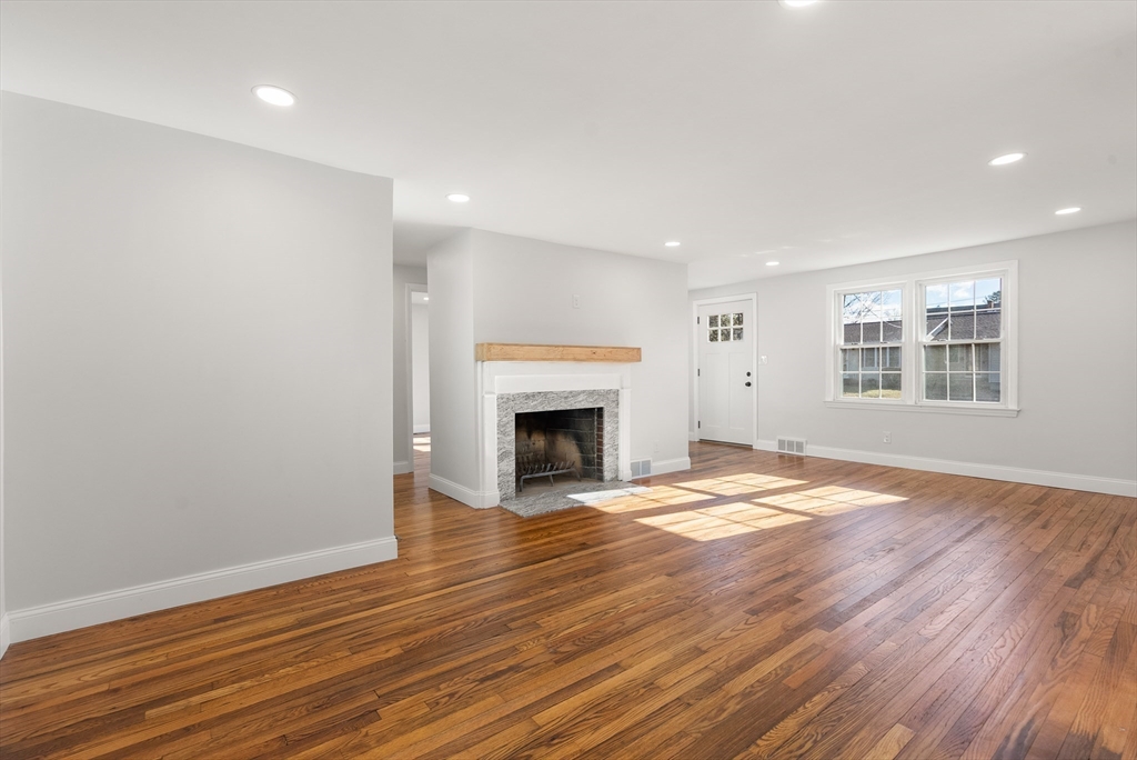 48 Beeler Avenue Chicopee, MA 01020 - Photo 11 of 30 a view of empty room with wooden floor and fireplace