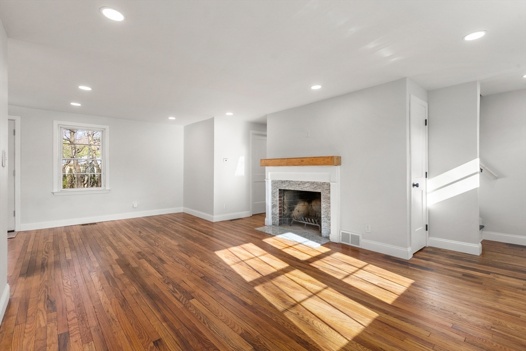 48 Beeler Avenue Chicopee, MA 01020 - Photo 12 of 30 a view of empty room with wooden floor and fireplace