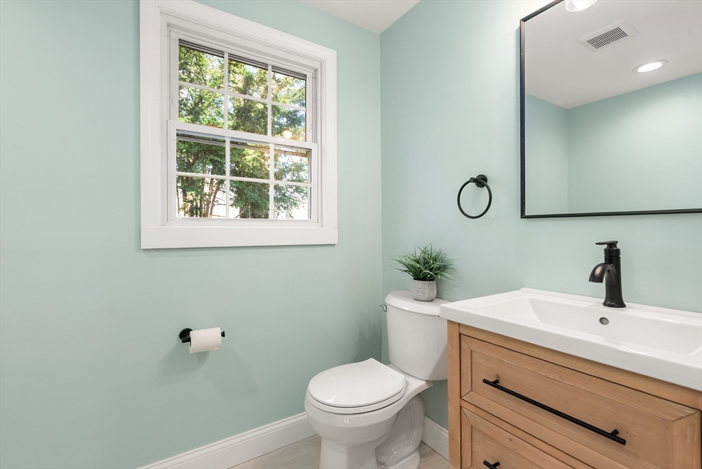 48 Beeler Avenue Chicopee, MA 01020 - Photo 25 of 30 a bathroom with a toilet sink and mirror
