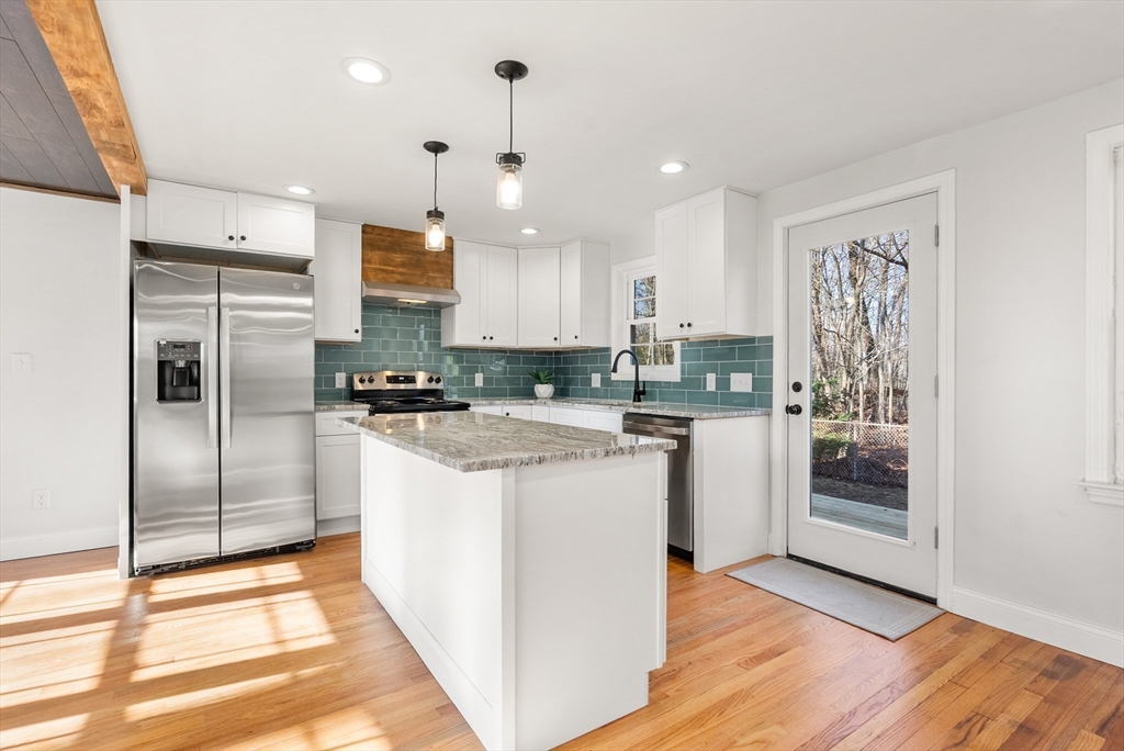 48 Beeler Avenue Chicopee, MA 01020 - Photo 4 of 30 a kitchen with stainless steel appliances granite countertop a refrigerator a oven a sink and a stove