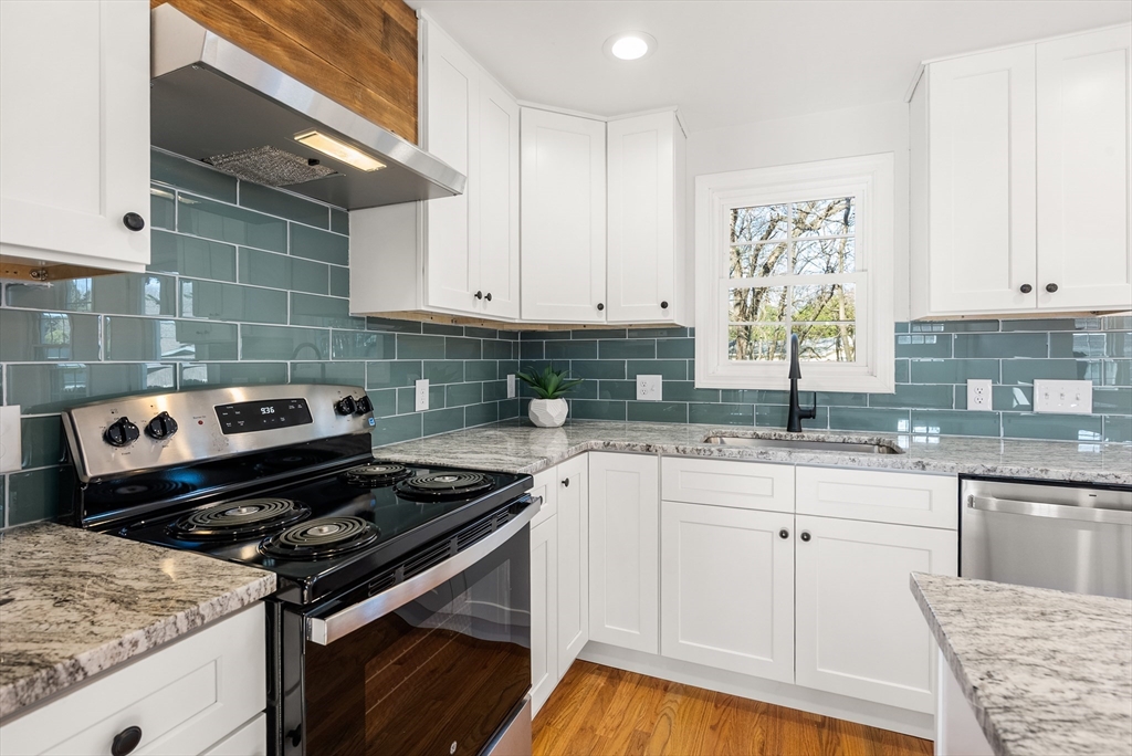 48 Beeler Avenue Chicopee, MA 01020 - Photo 6 of 30 a kitchen with a stove and white cabinets