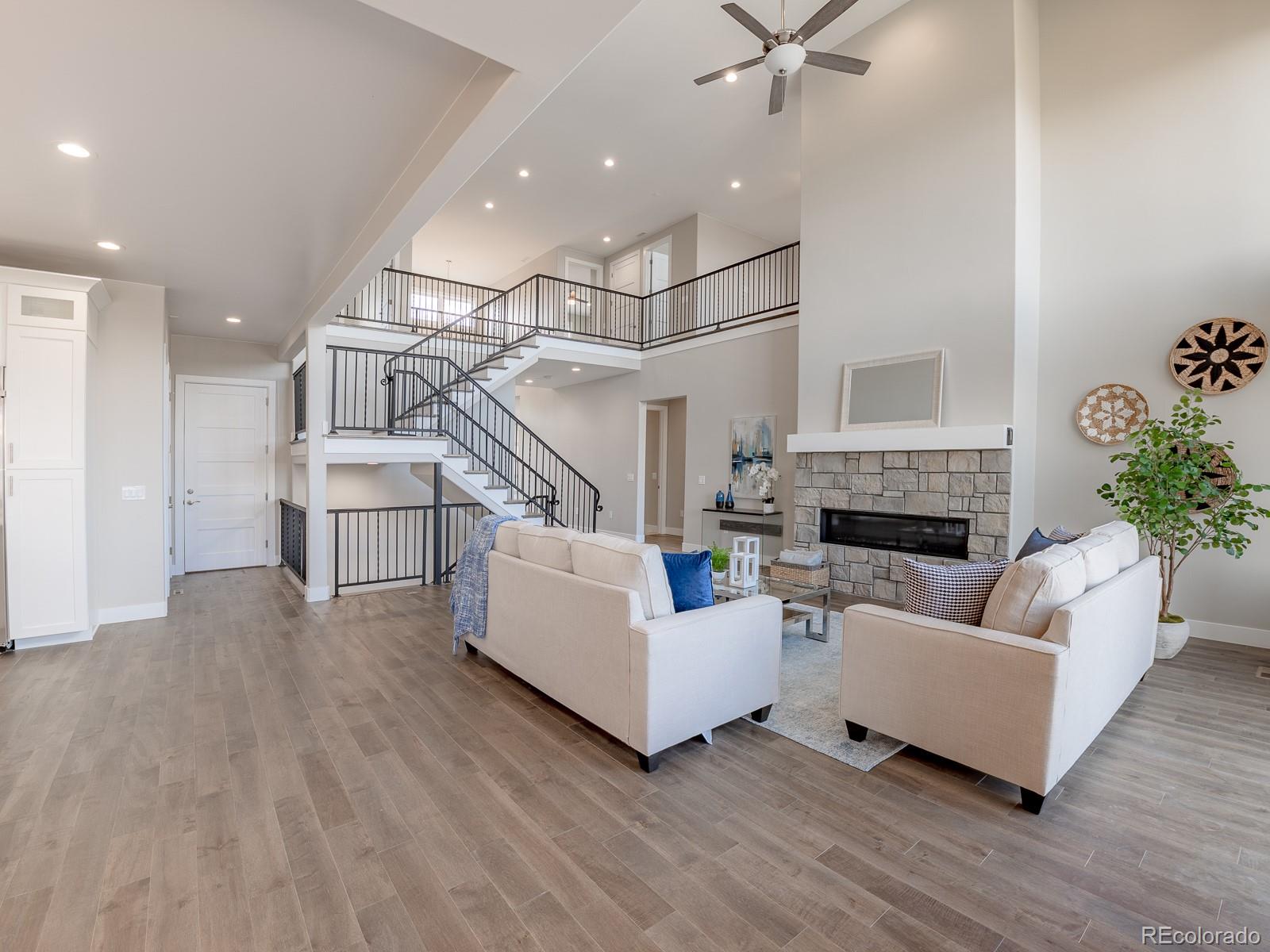 9540 Orion Way Arvada, CO 80007 - Photo 12 of 40 a living room with furniture and a fireplace