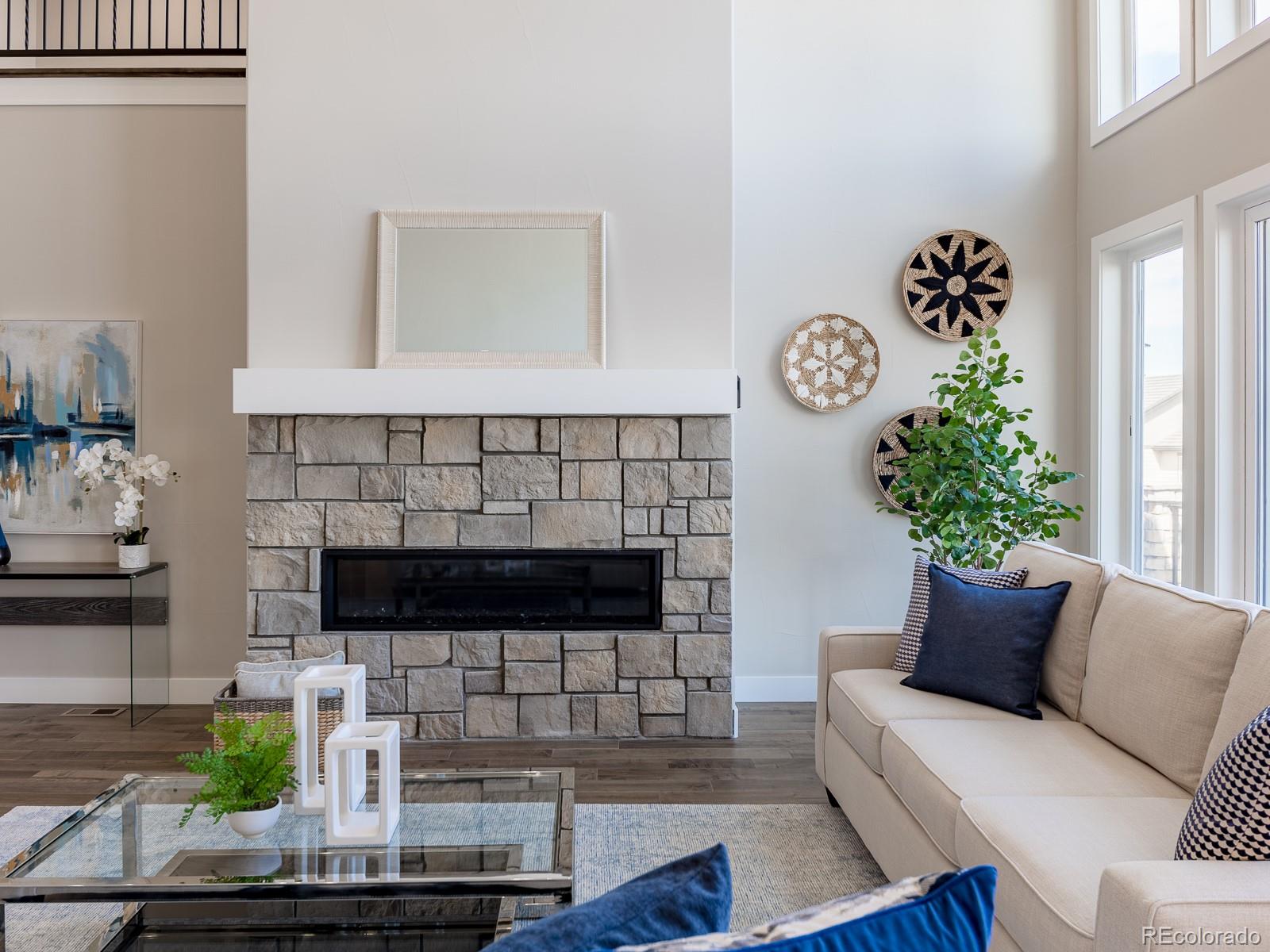 9540 Orion Way Arvada, CO 80007 - Photo 13 of 40 a living room with furniture and a fireplace