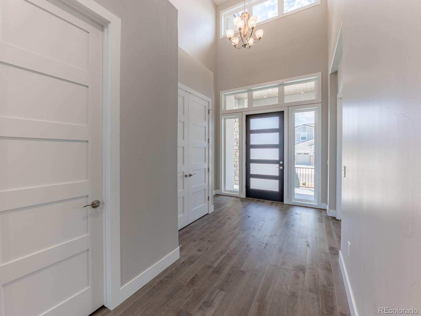 9540 Orion Way Arvada, CO 80007 - Photo 14 of 40 wooden floor in an empty room with a window