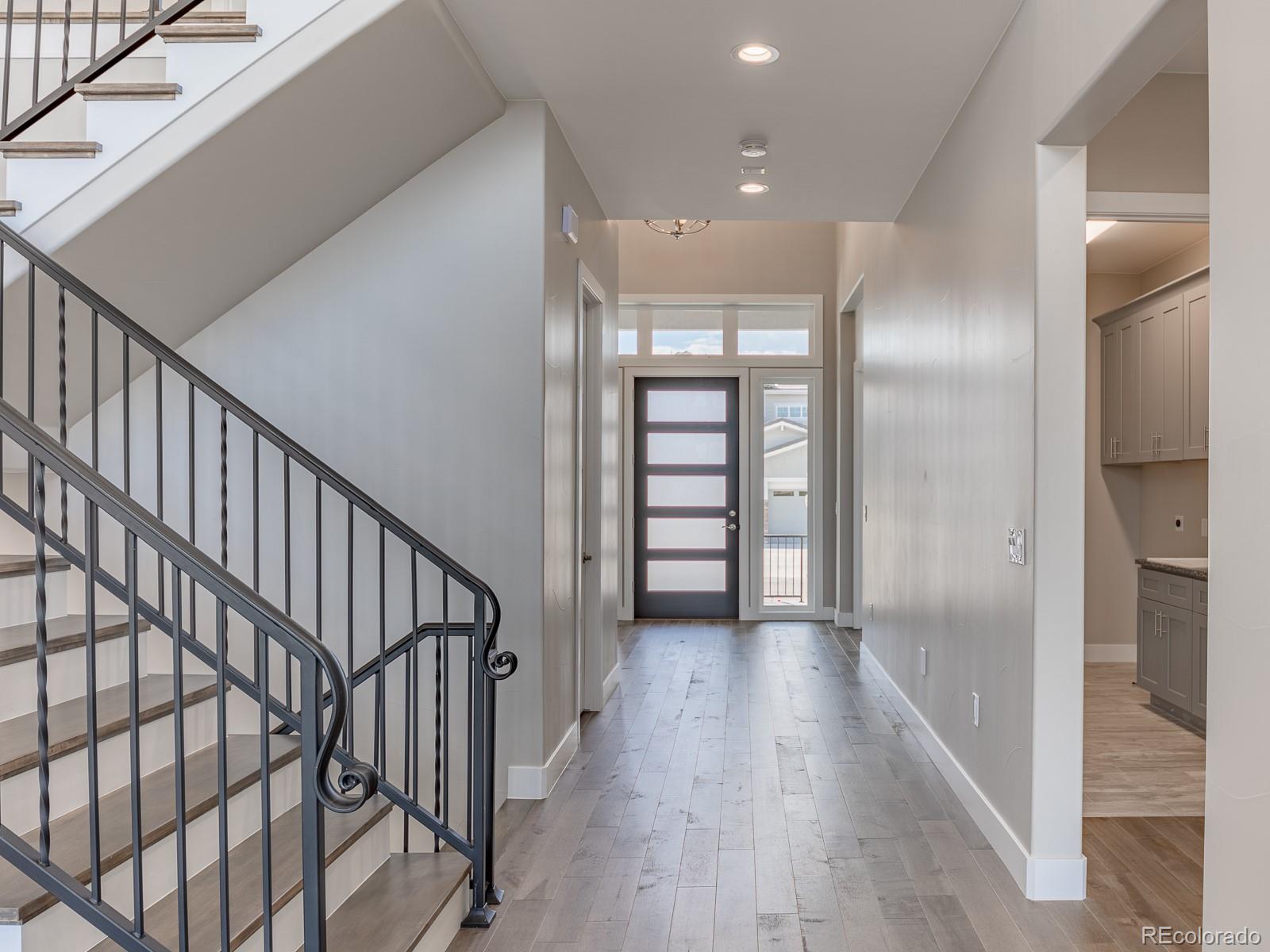 9540 Orion Way Arvada, CO 80007 - Photo 15 of 40 a view of a hallway with wooden floor