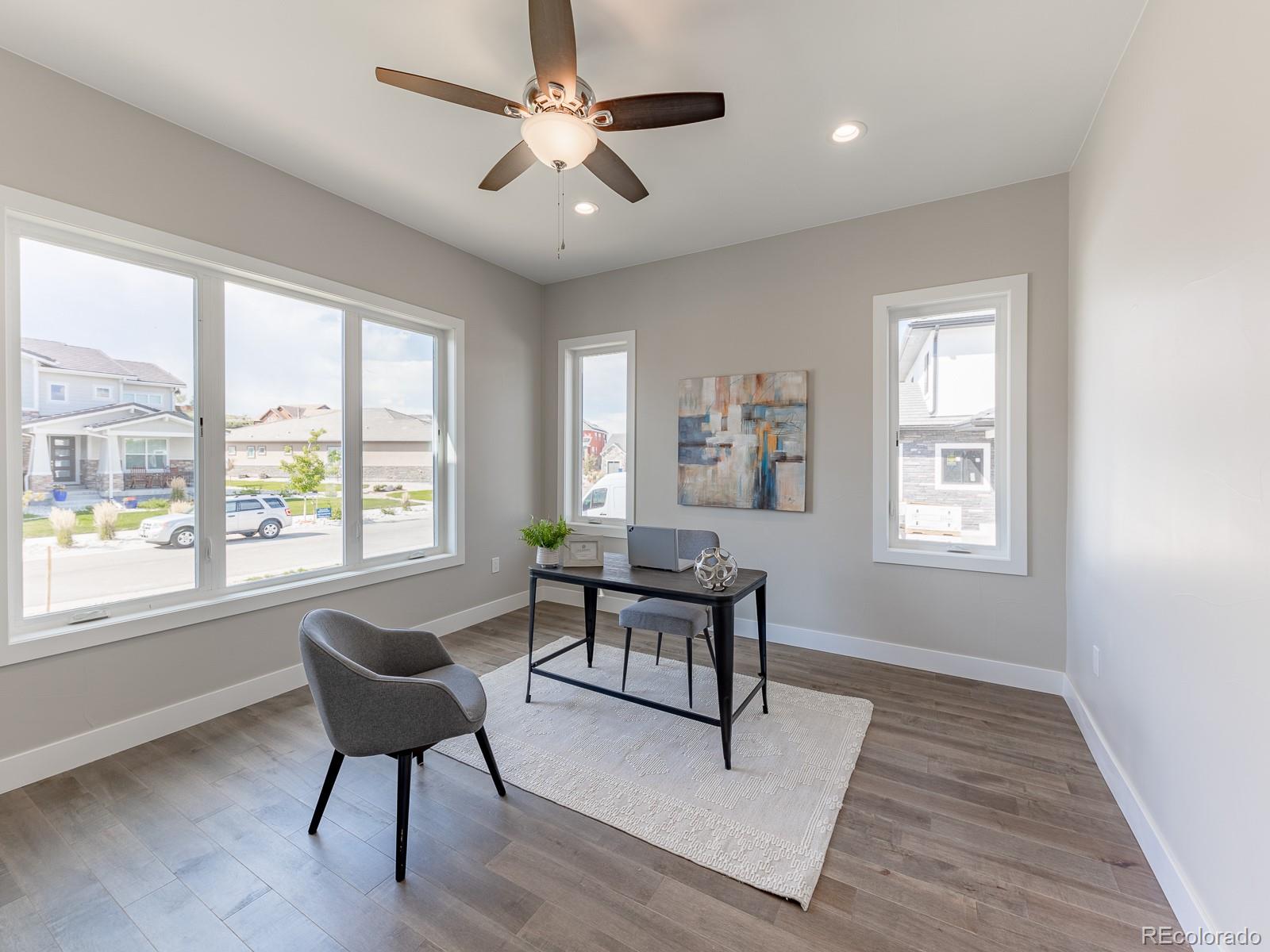 9540 Orion Way Arvada, CO 80007 - Photo 16 of 40 a living room with furniture a window and a chandelier