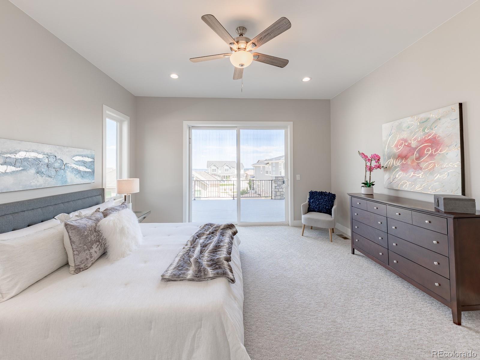 9540 Orion Way Arvada, CO 80007 - Photo 17 of 40 a bedroom with a large bed and a window