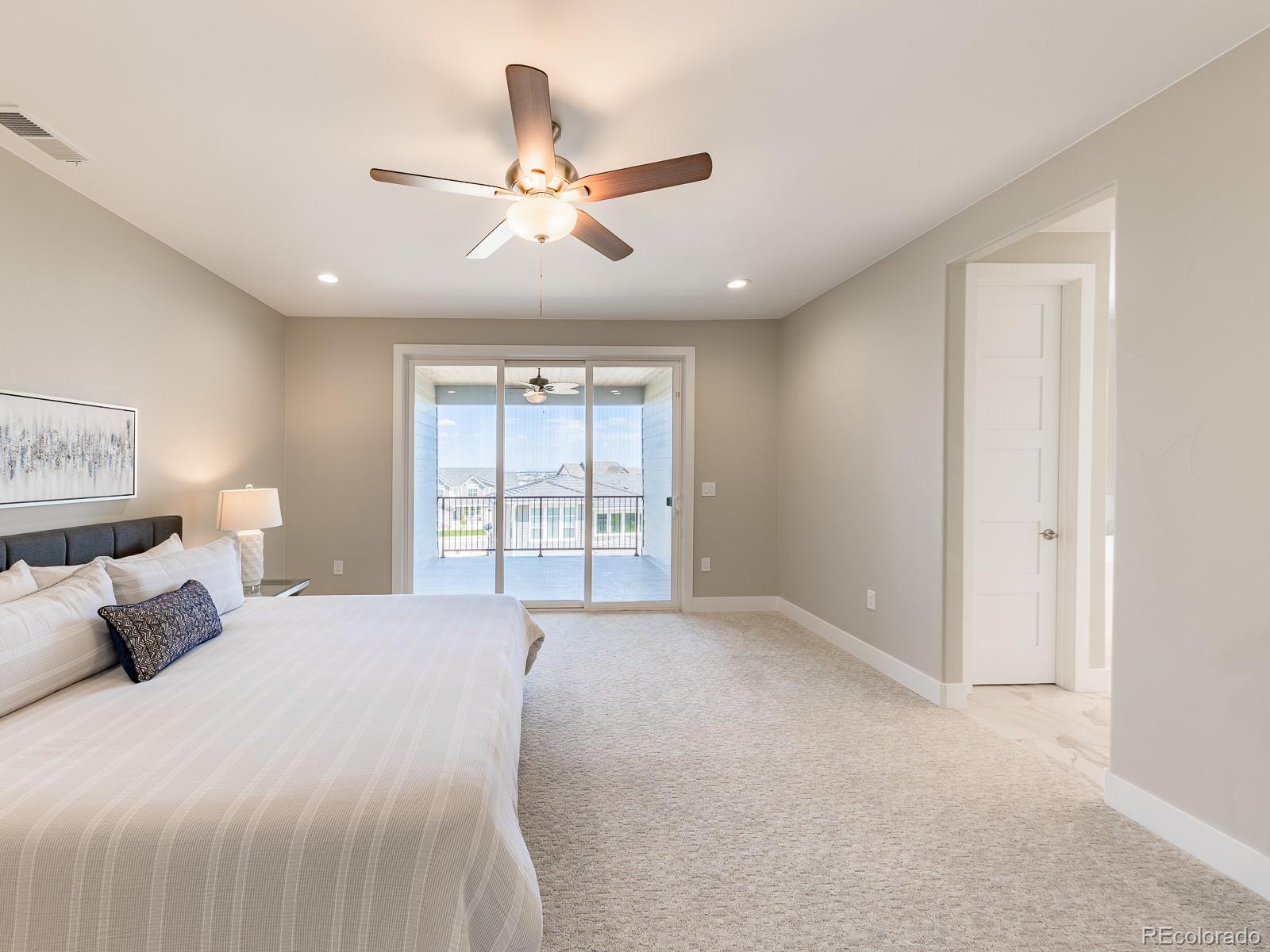 9540 Orion Way Arvada, CO 80007 - Photo 22 of 40 a bedroom with a large bed and a window