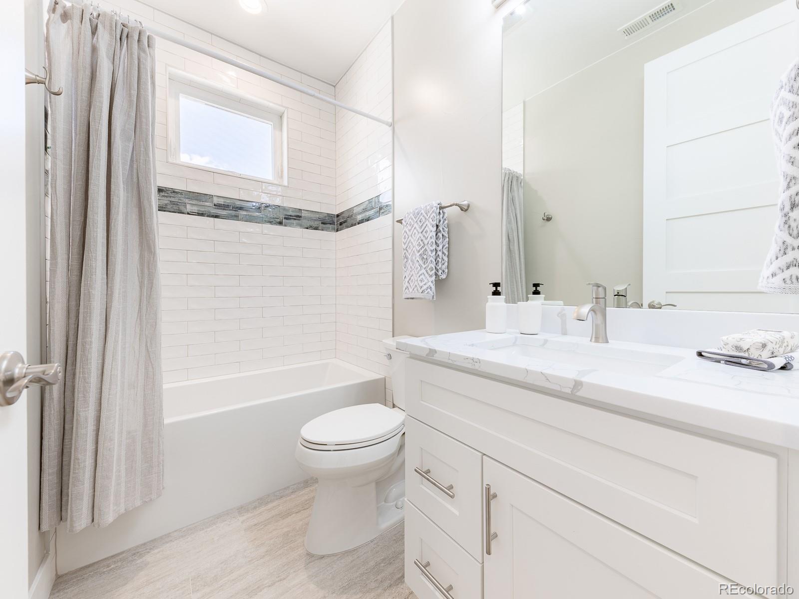 9540 Orion Way Arvada, CO 80007 - Photo 27 of 40 a bathroom with a granite countertop sink toilet and shower