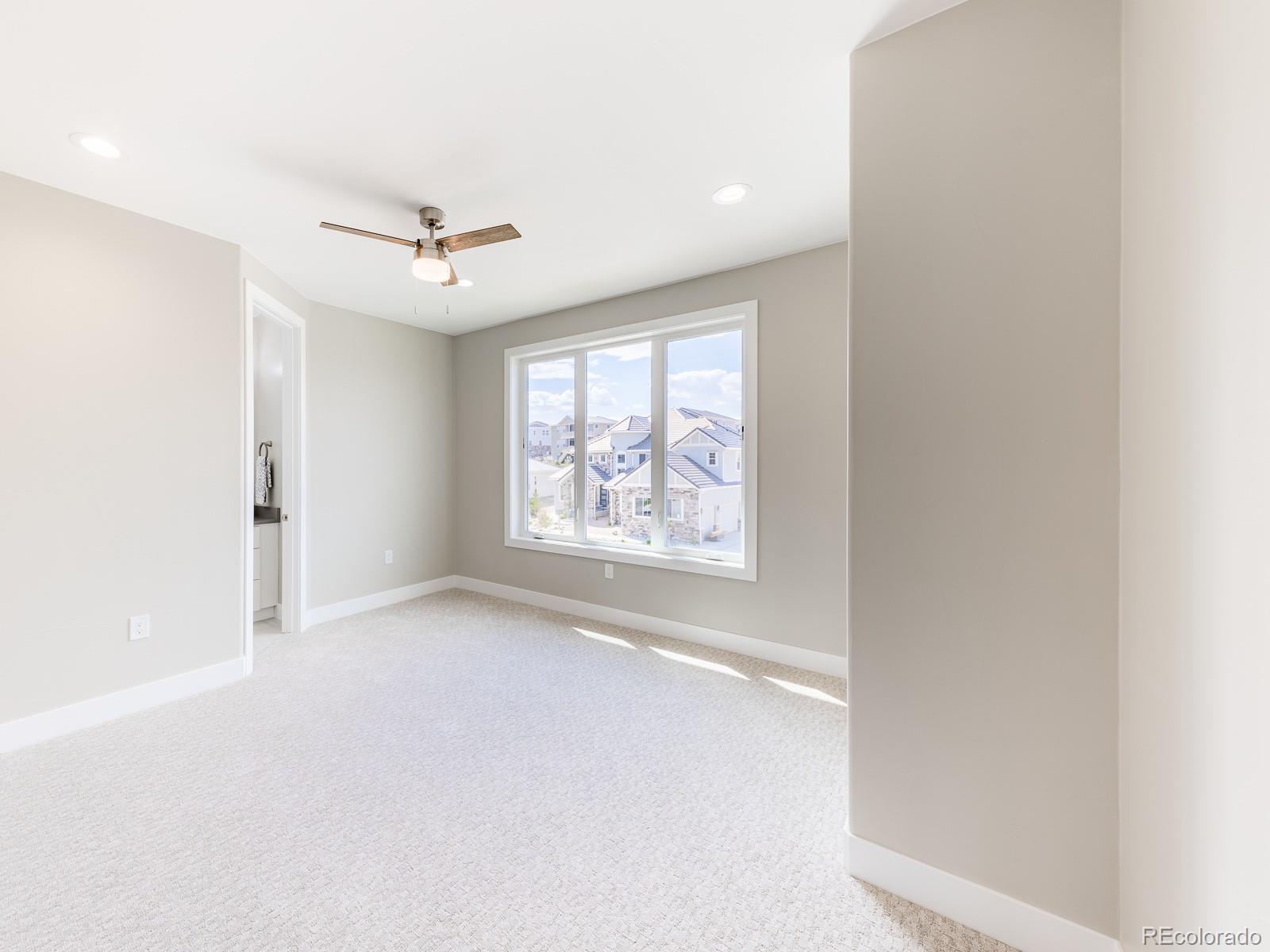 9540 Orion Way Arvada, CO 80007 - Photo 28 of 40 an empty room with windows and fan