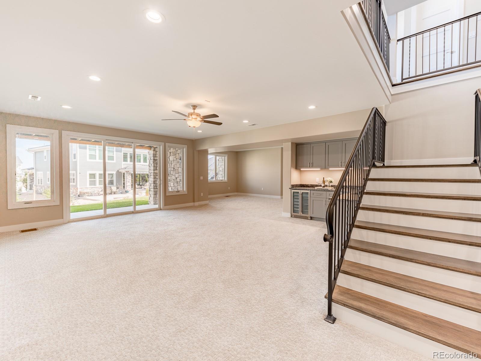 9540 Orion Way Arvada, CO 80007 - Photo 30 of 40 a view of an empty room with wooden floor and a window