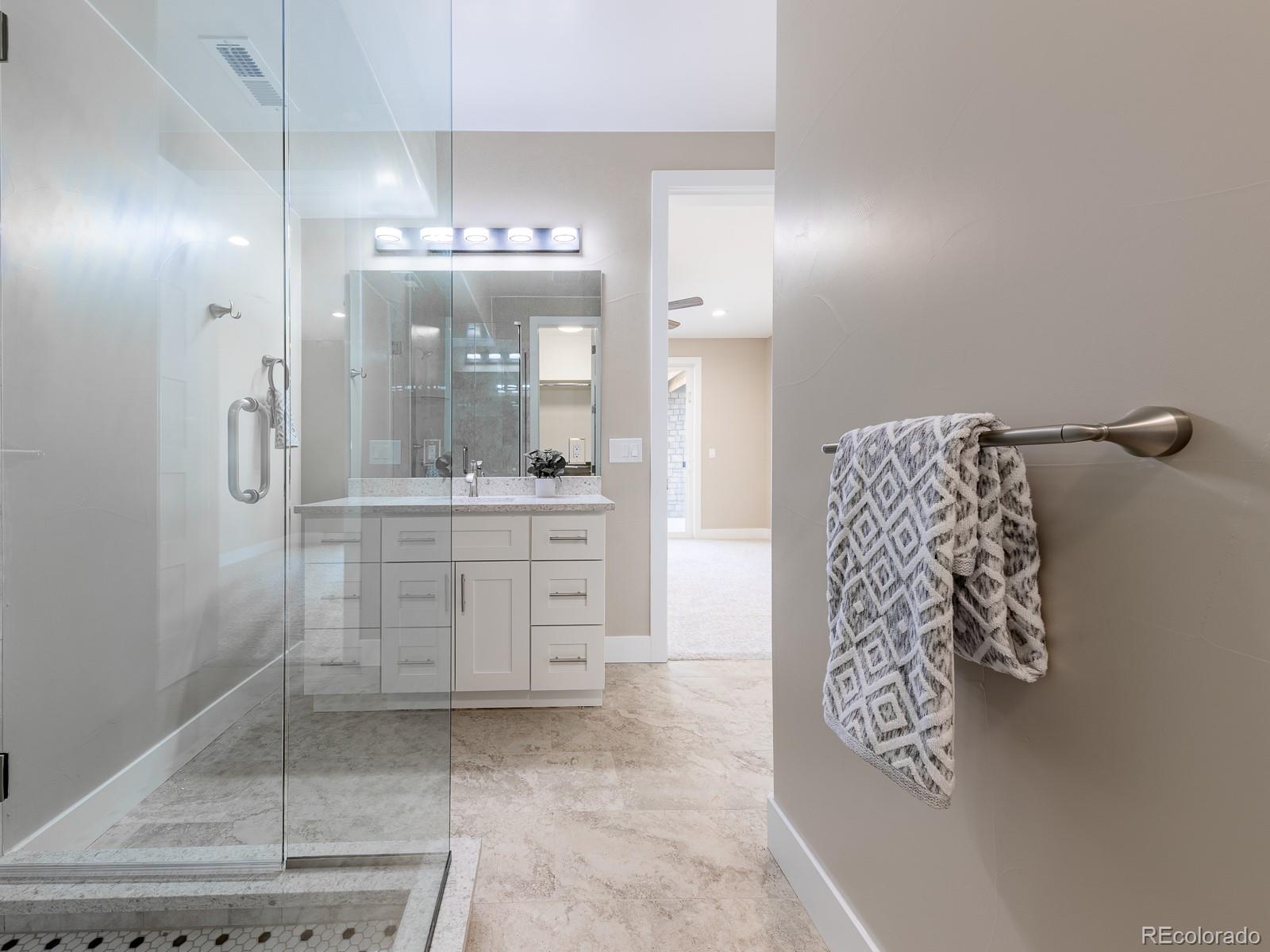 9540 Orion Way Arvada, CO 80007 - Photo 33 of 40 a bathroom with a sink and a mirror