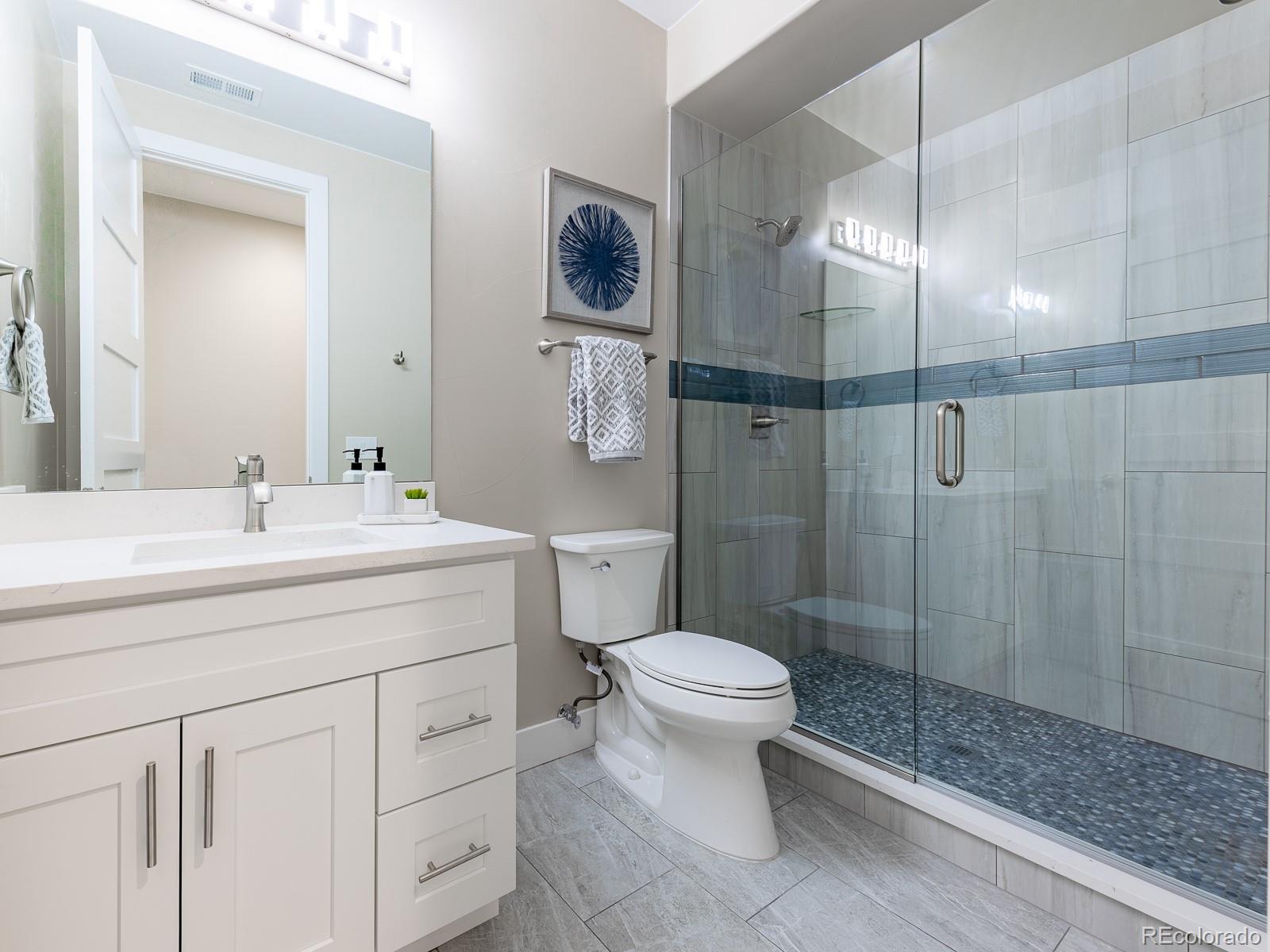 9540 Orion Way Arvada, CO 80007 - Photo 35 of 40 a bathroom with a sink toilet and shower