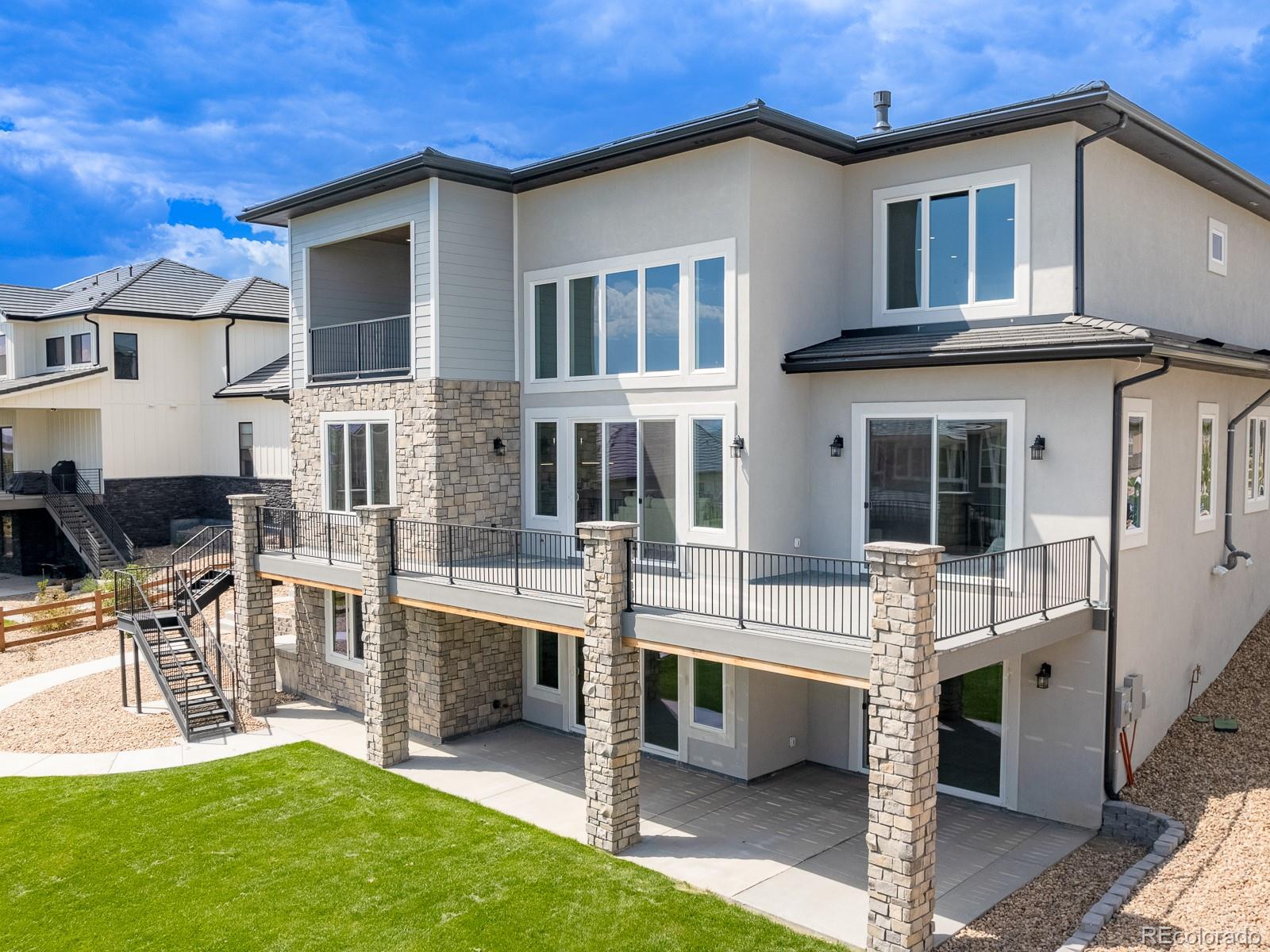9540 Orion Way Arvada, CO 80007 - Photo 36 of 40 a view of house with a yard