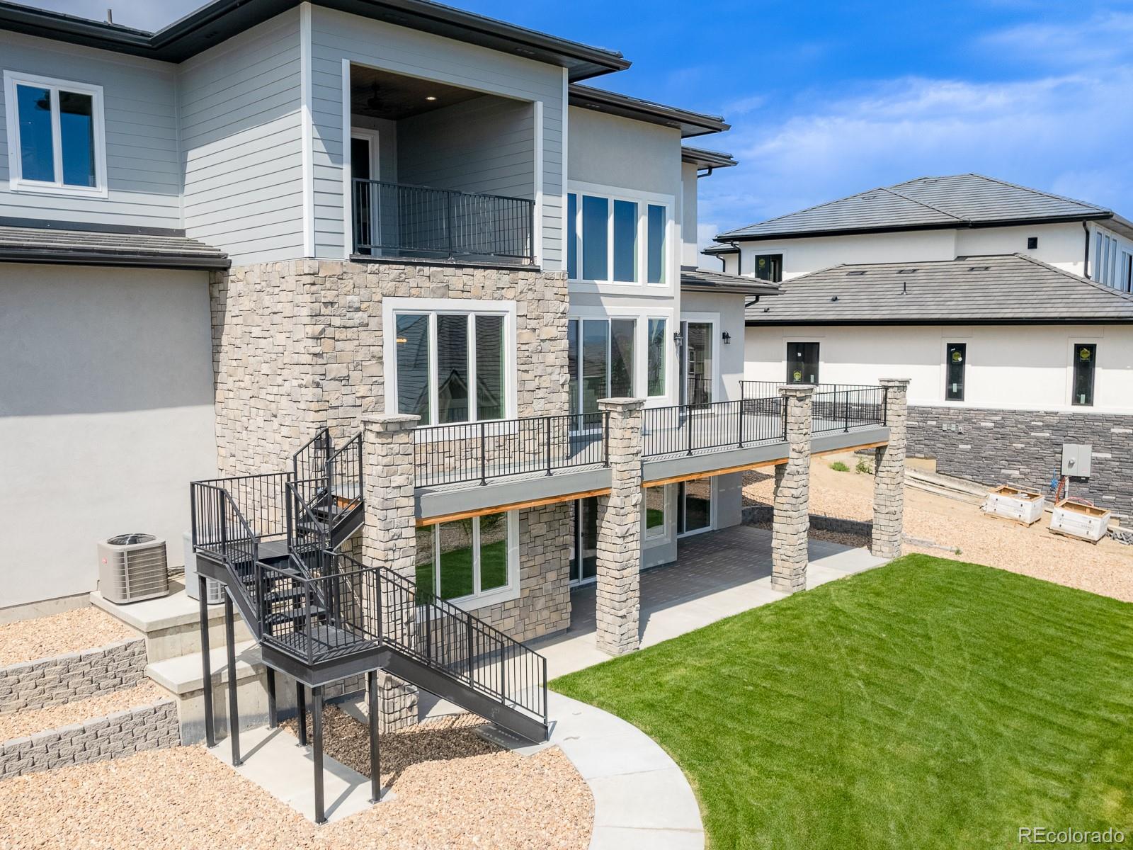 9540 Orion Way Arvada, CO 80007 - Photo 37 of 40 a view of a house with a backyard and sitting area