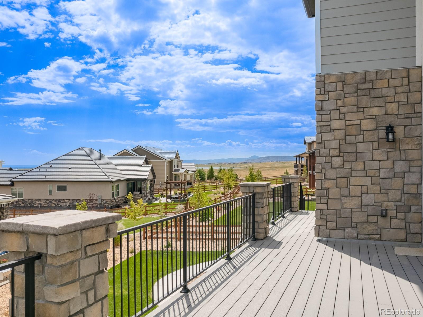 9540 Orion Way Arvada, CO 80007 - Photo 38 of 40 a view of a balcony with wooden floor and city view
