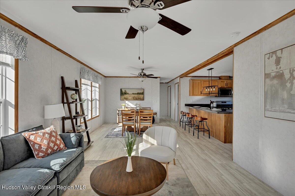 299 Hyspot Road, Unit 4C Greenfield, NY 12833 - Photo 11 of 41 a living room with furniture and a wooden floor