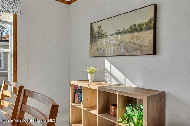 a view of a room with painting on the wall