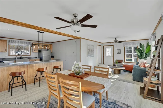 a dining room with furniture a rug and wooden floor