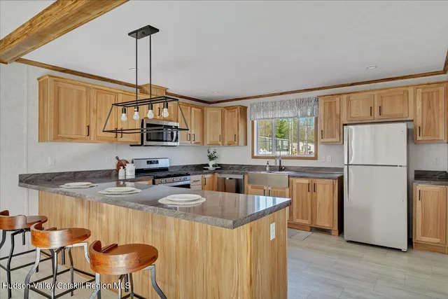 a kitchen with refrigerator cabinets and wooden floor