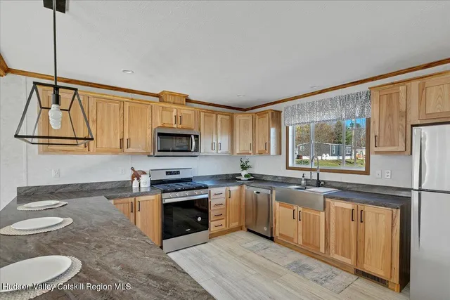 a kitchen with stainless steel appliances granite countertop a stove sink and cabinets
