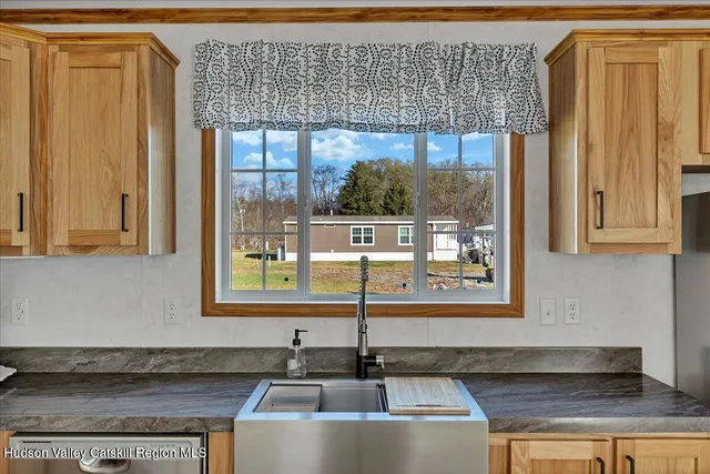 a kitchen with granite countertop a sink and a window