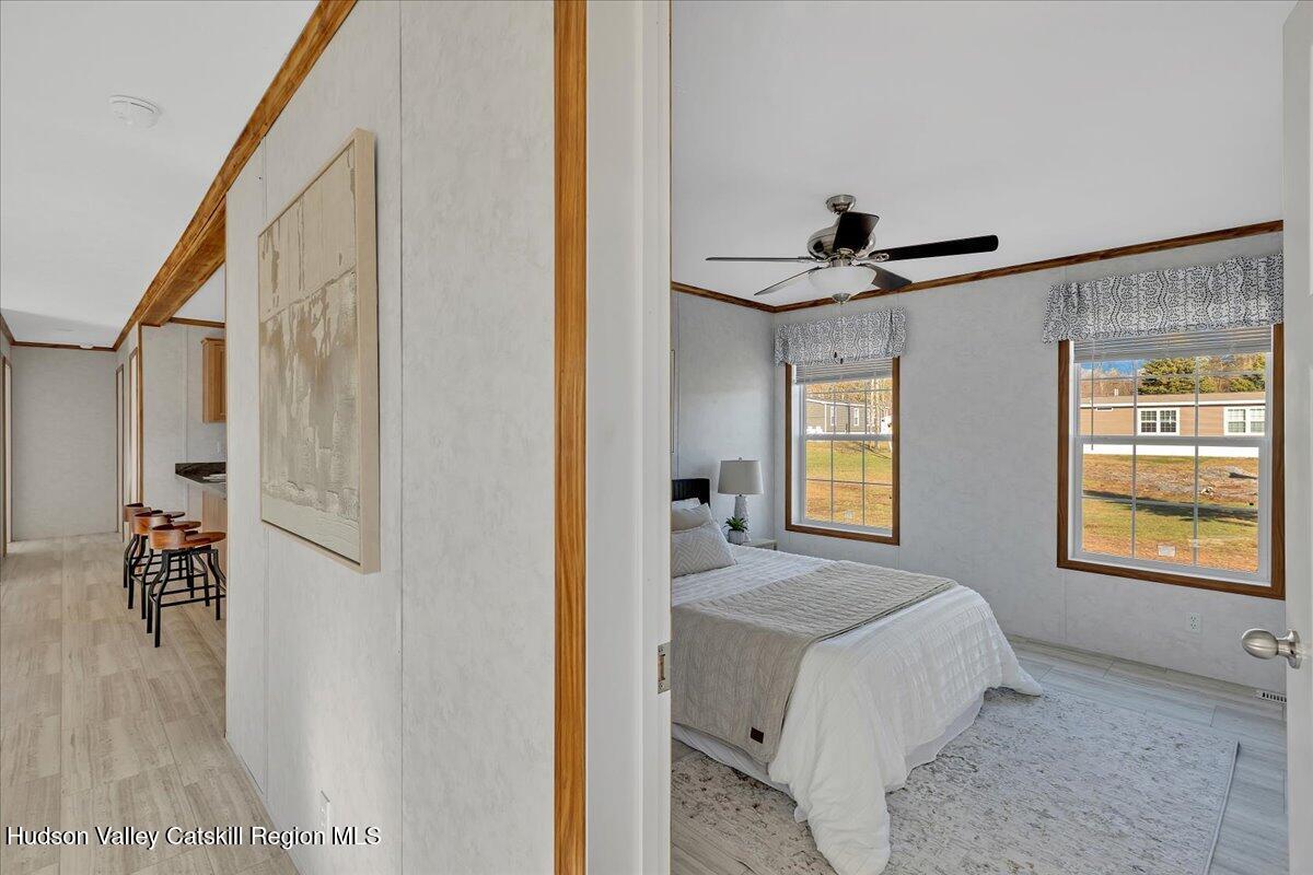 299 Hyspot Road, Unit 4C Greenfield, NY 12833 - Photo 24 of 41 a bedroom with a bed and a chandelier