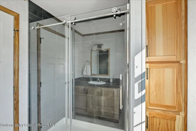 a view of an empty room with a window and a ceiling fan