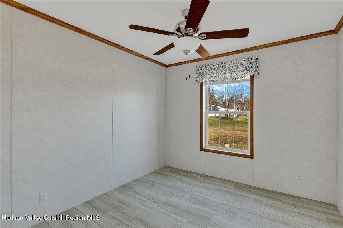 299 Hyspot Road, Unit 4C Greenfield, NY 12833 - Photo 32 of 41 a view of an empty room with a window and a ceiling fan