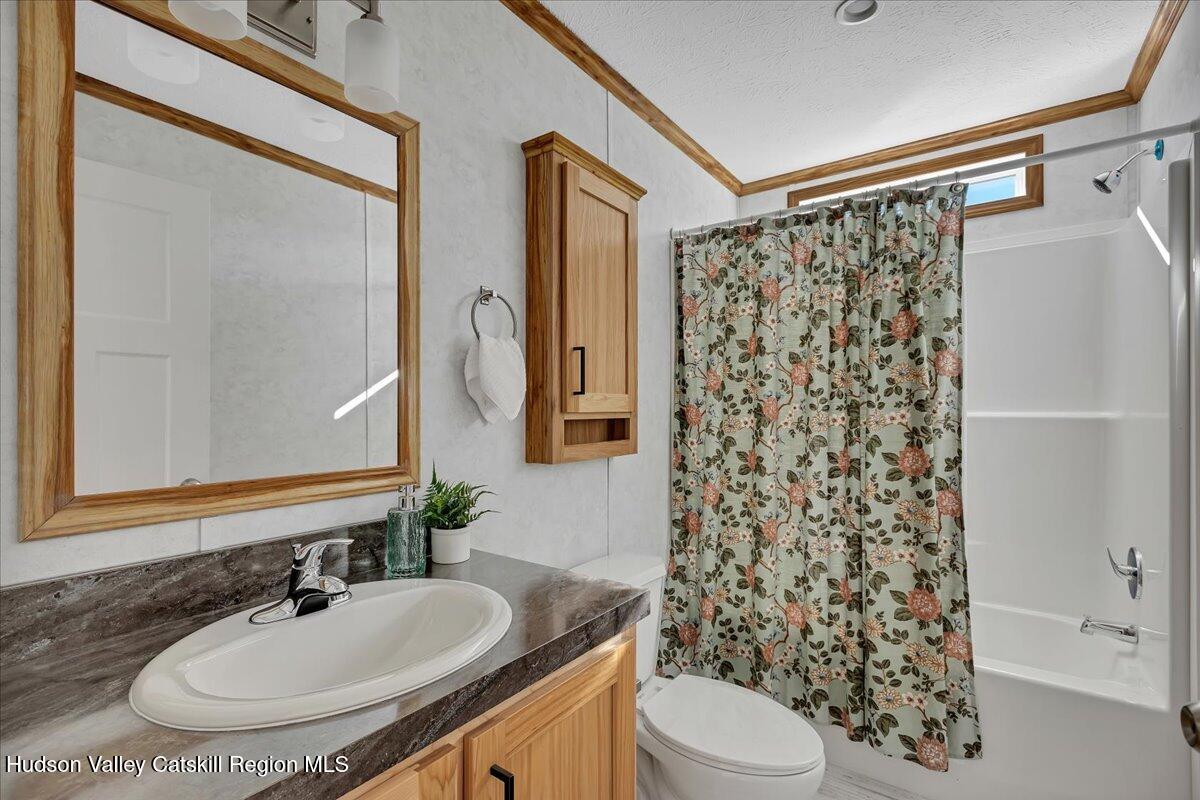 299 Hyspot Road, Unit 4C Greenfield, NY 12833 - Photo 35 of 41 a bathroom with a sink toilet a shower and a mirror