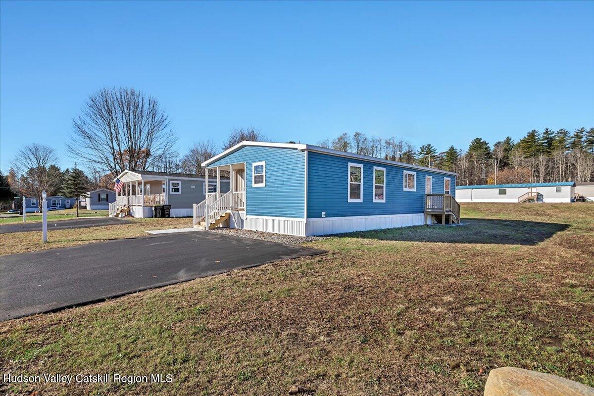 299 Hyspot Road, Unit 4C Greenfield, NY 12833 - Photo 37 of 41 a front view of a house with a yard