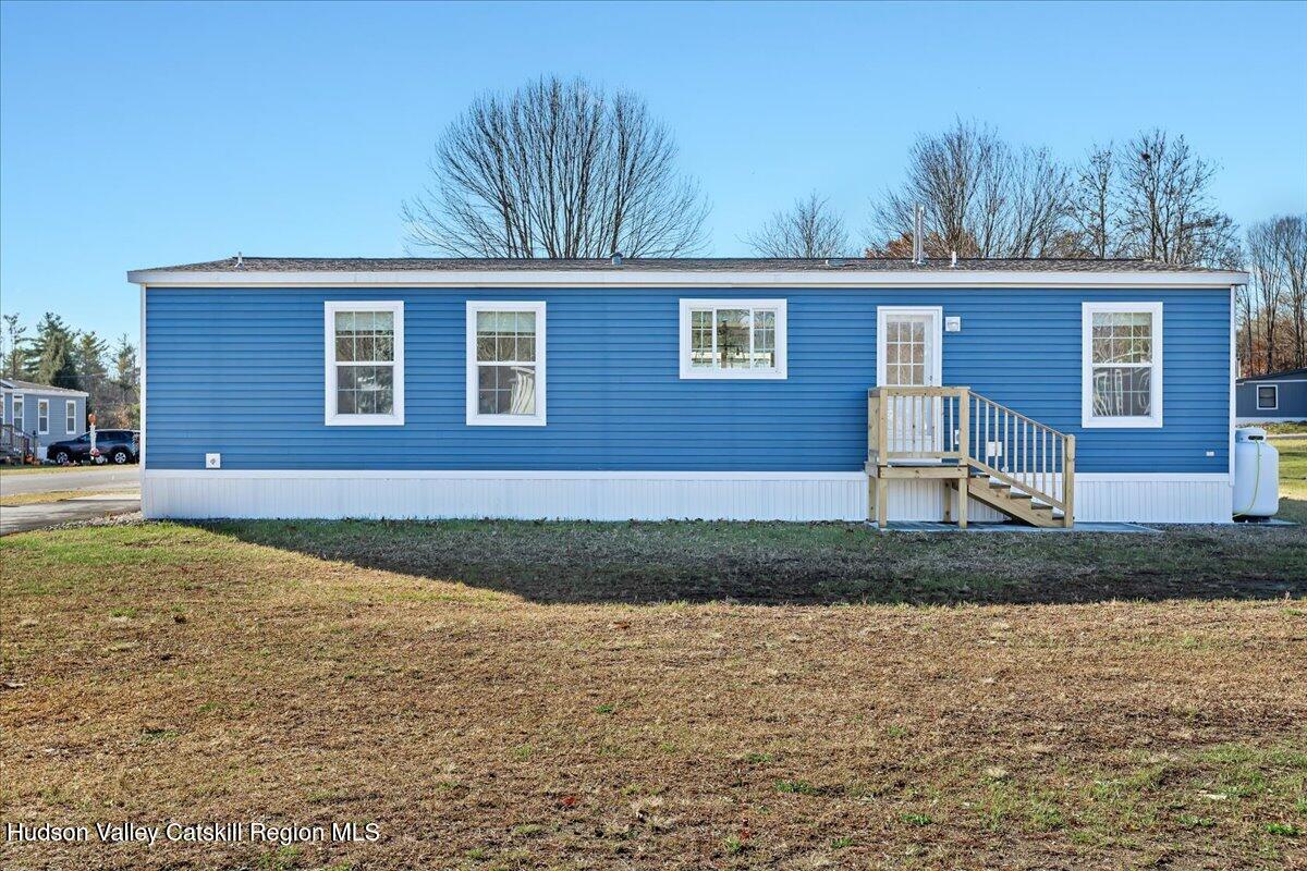 299 Hyspot Road, Unit 4C Greenfield, NY 12833 - Photo 39 of 41 a view of a house with a yard