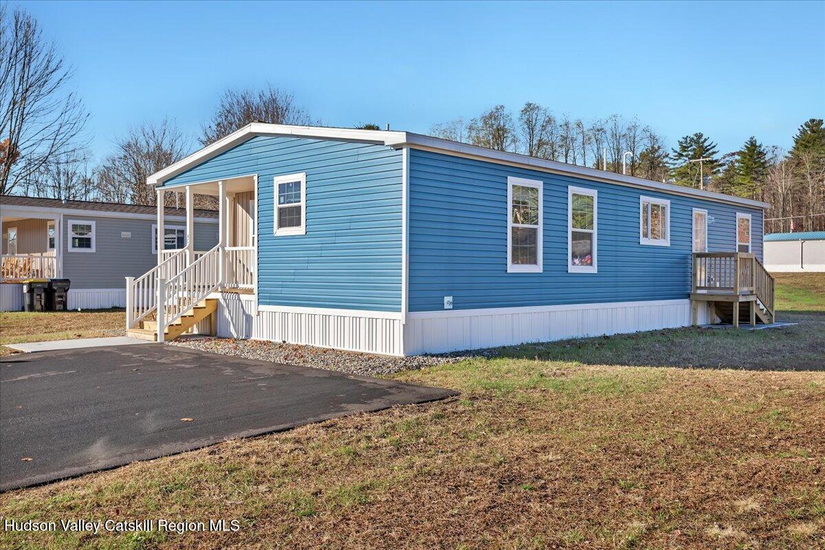 299 Hyspot Road, Unit 4C Greenfield, NY 12833 - Photo 4 of 41 a view of a house with a yard