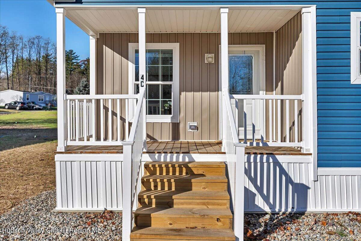 299 Hyspot Road, Unit 4C Greenfield, NY 12833 - Photo 5 of 41 front view of a house with a fence