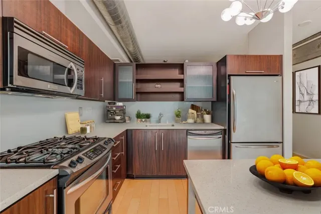 a kitchen with stainless steel appliances granite countertop a stove and a refrigerator