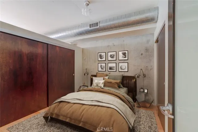 a bedroom with a bed and a closet