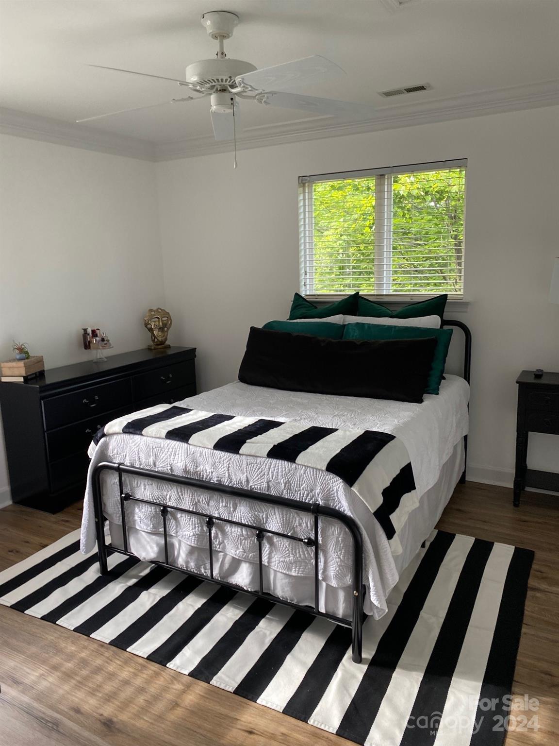 18225 Taffrail Way Cornelius, NC 28031 - Photo 17 of 30 a bedroom with a bed dresser and a window