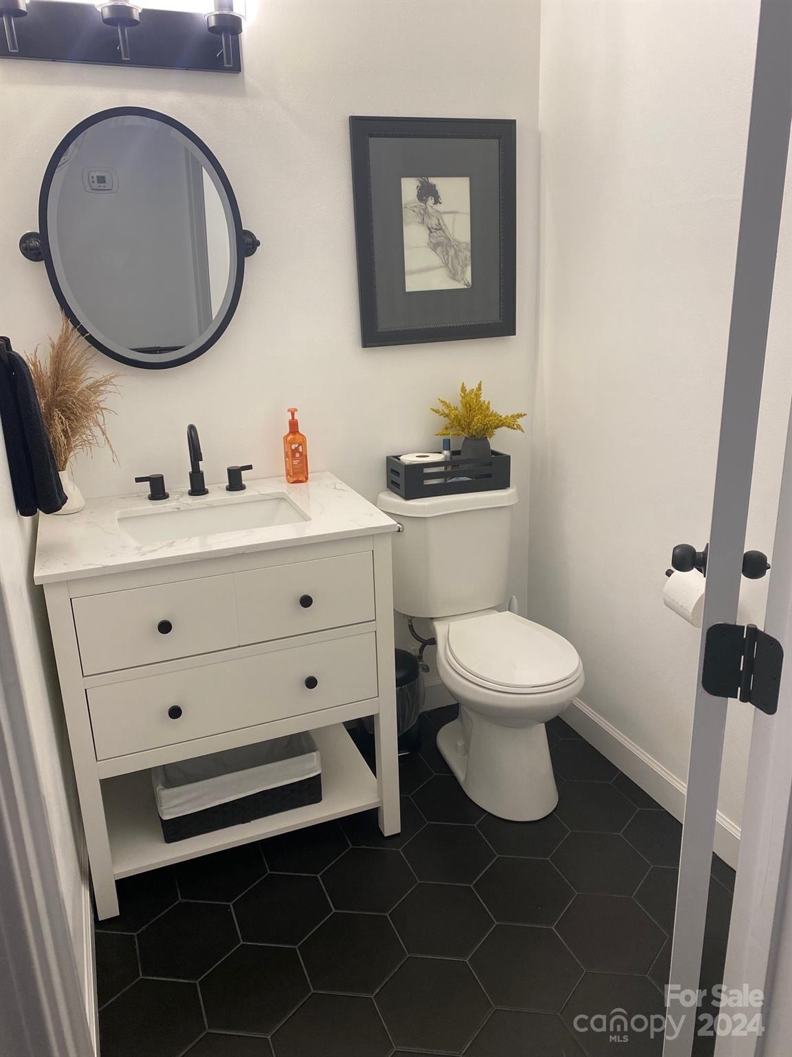 18225 Taffrail Way Cornelius, NC 28031 - Photo 22 of 30 a bathroom with a toilet a sink and mirror