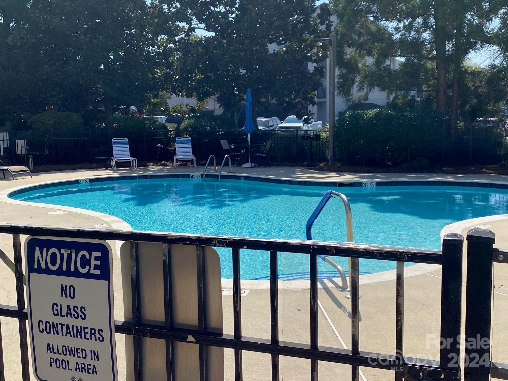 18225 Taffrail Way Cornelius, NC 28031 - Photo 29 of 30 a view of swimming pool with a bench and trees