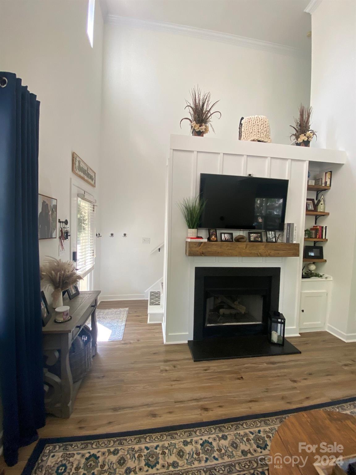 18225 Taffrail Way Cornelius, NC 28031 - Photo 5 of 30 a living room with furniture a fireplace and a flat screen tv