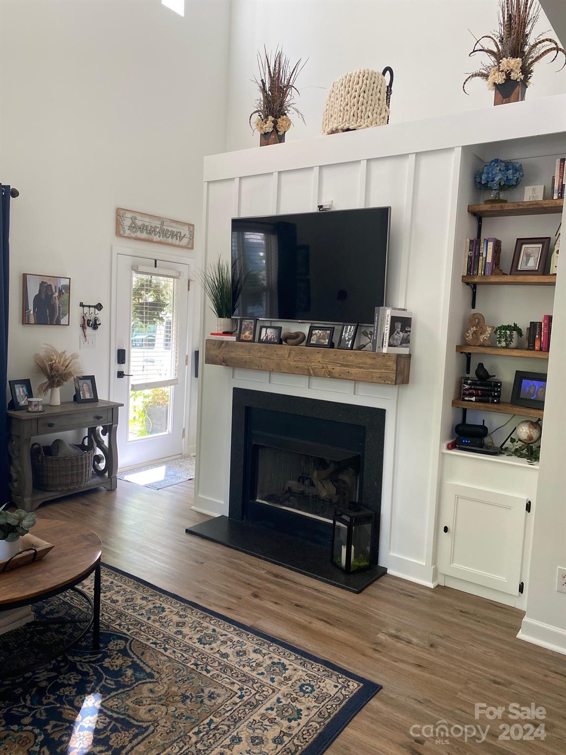 18225 Taffrail Way Cornelius, NC 28031 - Photo 7 of 30 a living room with furniture a flat screen tv and a fireplace