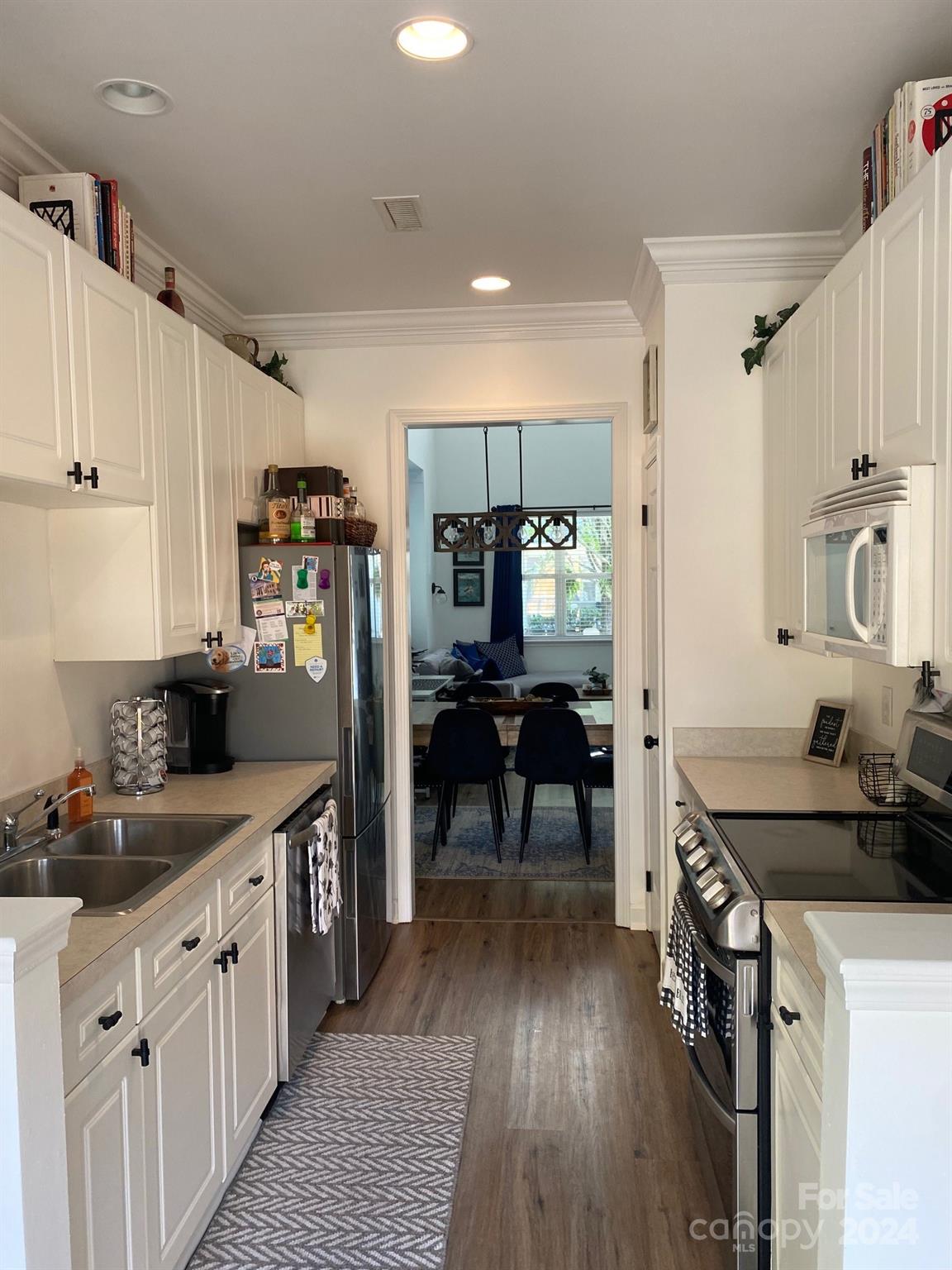 18225 Taffrail Way Cornelius, NC 28031 - Photo 8 of 30 a kitchen with a sink stove and cabinets