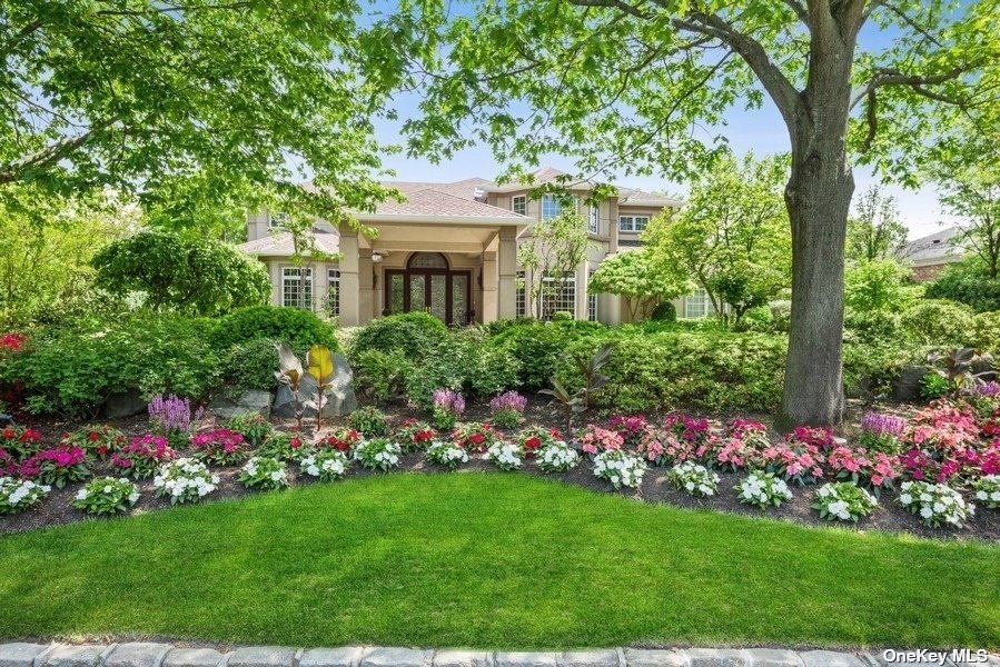 1323 Harbor Road Hewlett Harbor, NY 11557 - Photo 1 of 1 a front view of a house with a big yard and potted plants