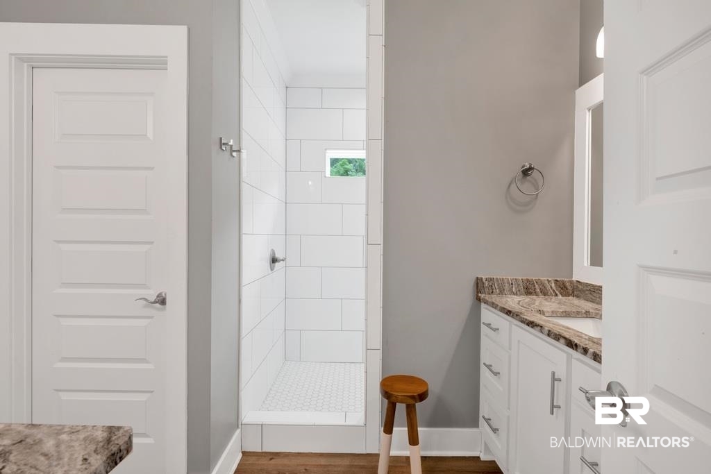 379 Pecan Ridge Boulevard Fairhope, AL 36532 - Photo 11 of 21 Walk-in shower with white subway tile surround and hexagonal floor tile
